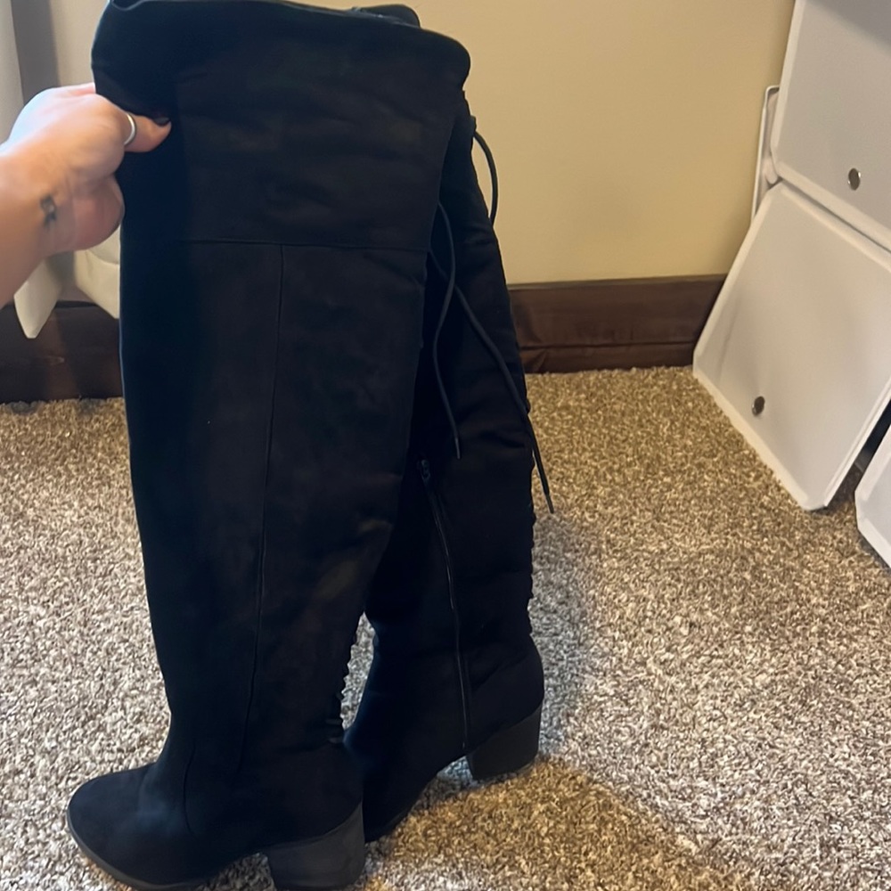 Knee high, suade, lace up boots.